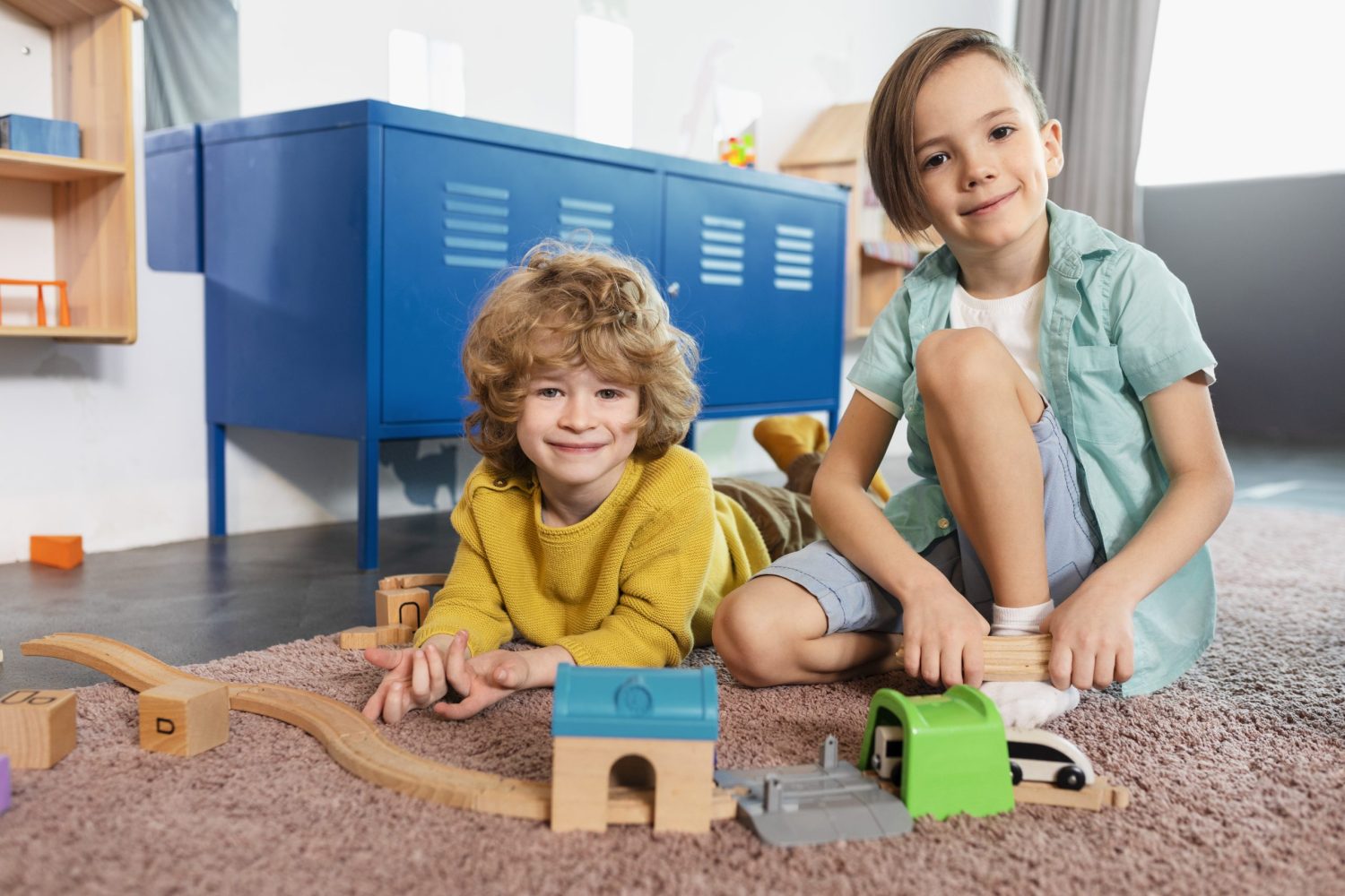 full-shot-smiley-kids-playing-together-with-train